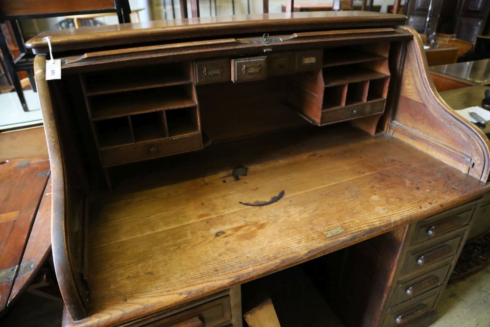 An oak roll-top desk, width 136cm, depth 86cm, height 126cm